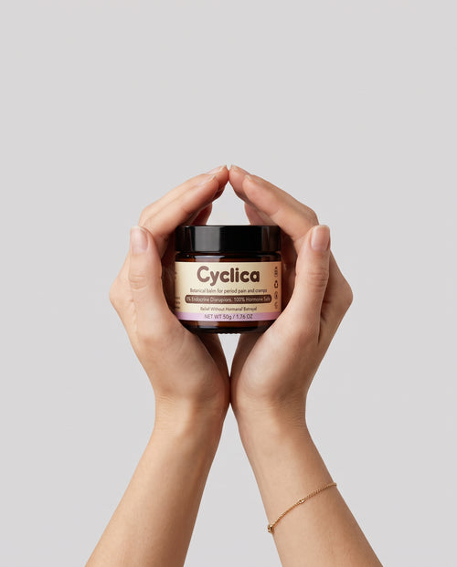 Hands holding a jar of Cyclica Botanical Balm