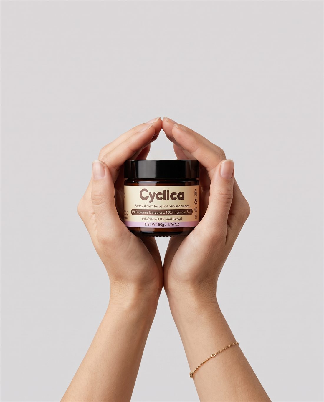 Two hands gently holding a jar of Cyclica balm